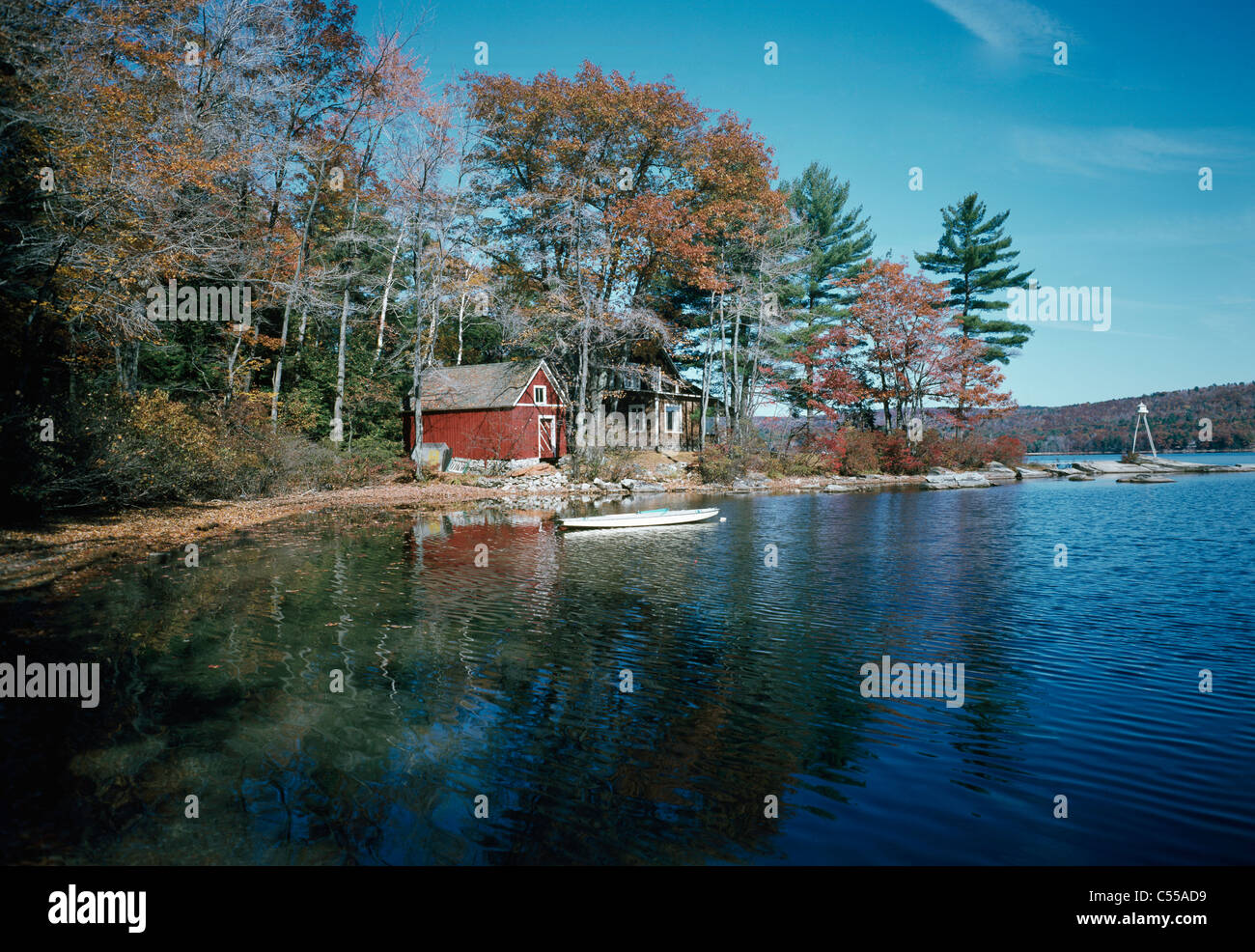 USA, New Hampshire, Spotford Lake, Rocky Point, log cabin and canoe Stock Photo
