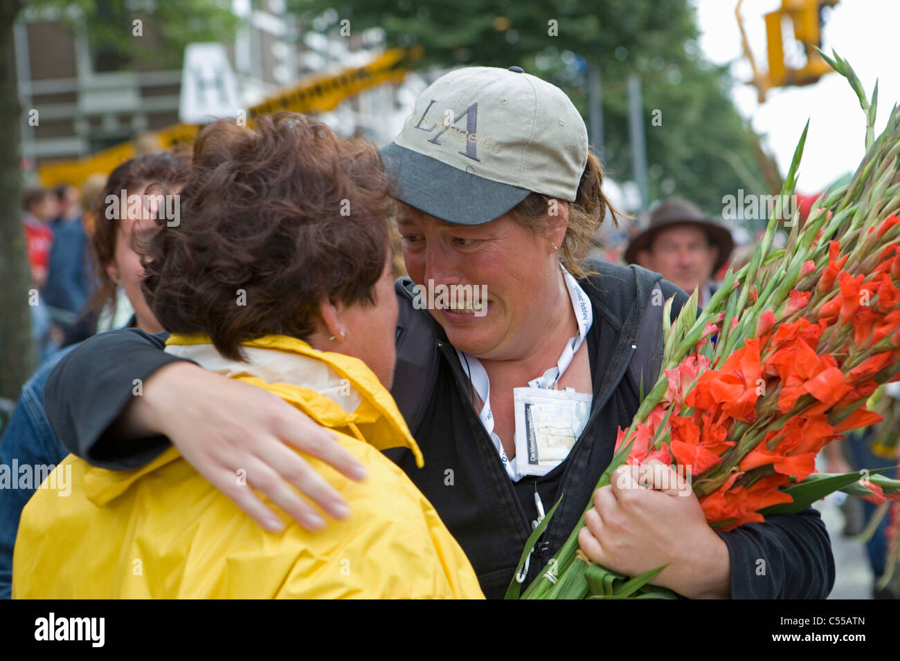 The Netherlands, Nijmegen. The Nijmegen Four-Day Walk. Supporter and participant with flowers at finish. Stock Photo