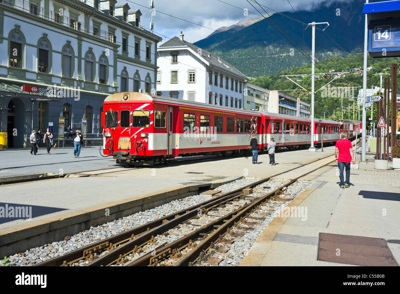 A Matterhorn Gotthard Bahn train arriving from Disentis direction at Brig Railway Station in Brig Switzerland Stock Photo