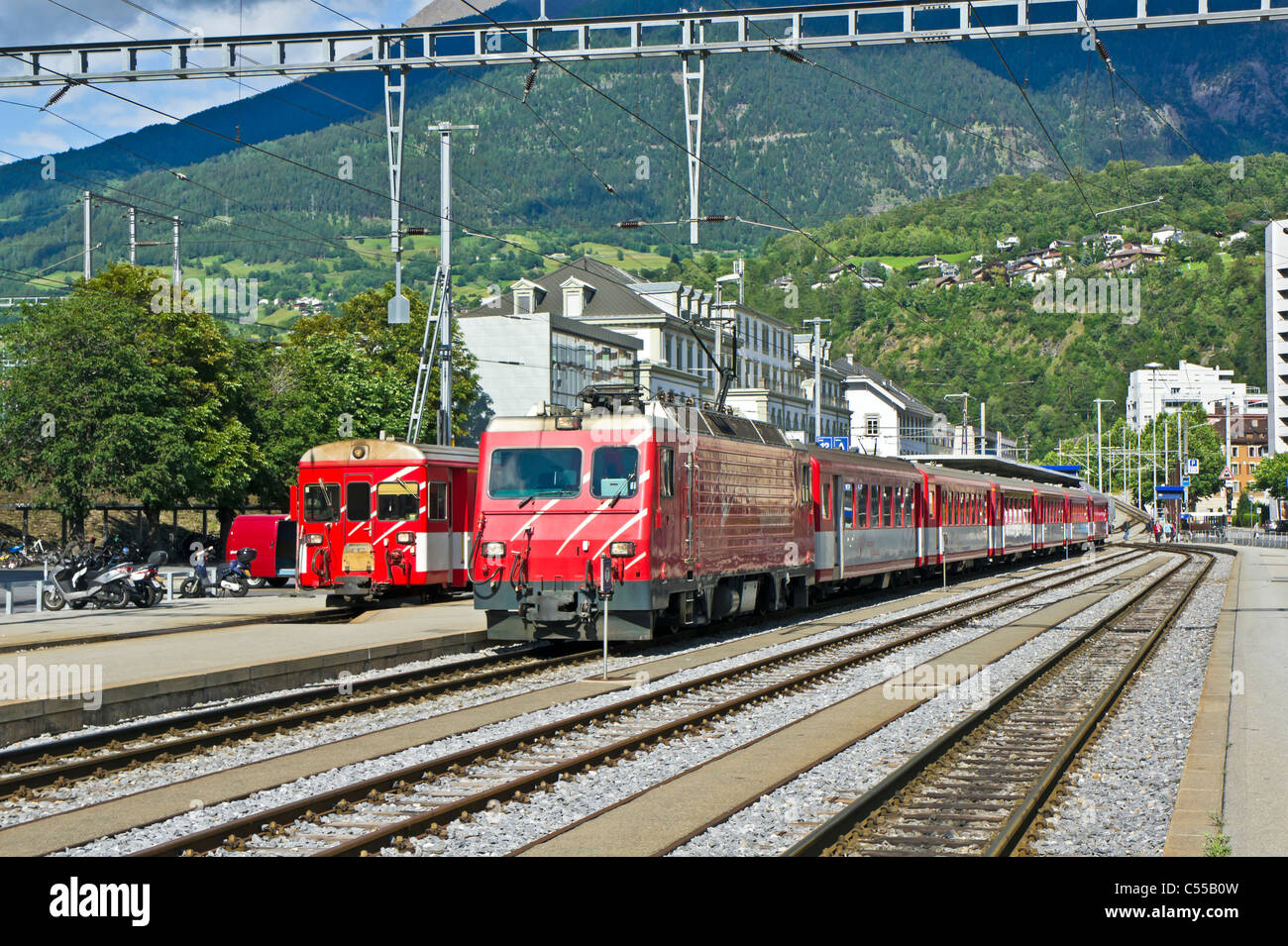 Two Matterhorn Gotthard Bahn trains at Brig Railway Station in Brig Switzerland Stock Photo