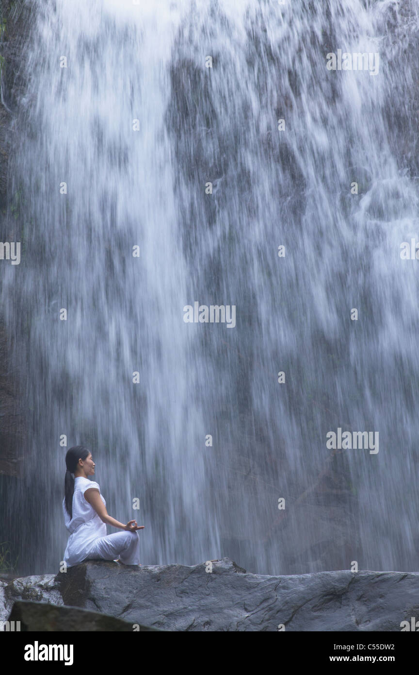 Person sitting on rock hi-res stock photography and images - Alamy