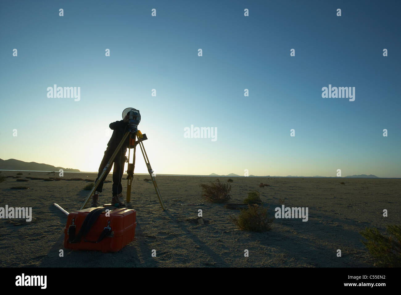 A person taking a photo in the grass field Stock Photo