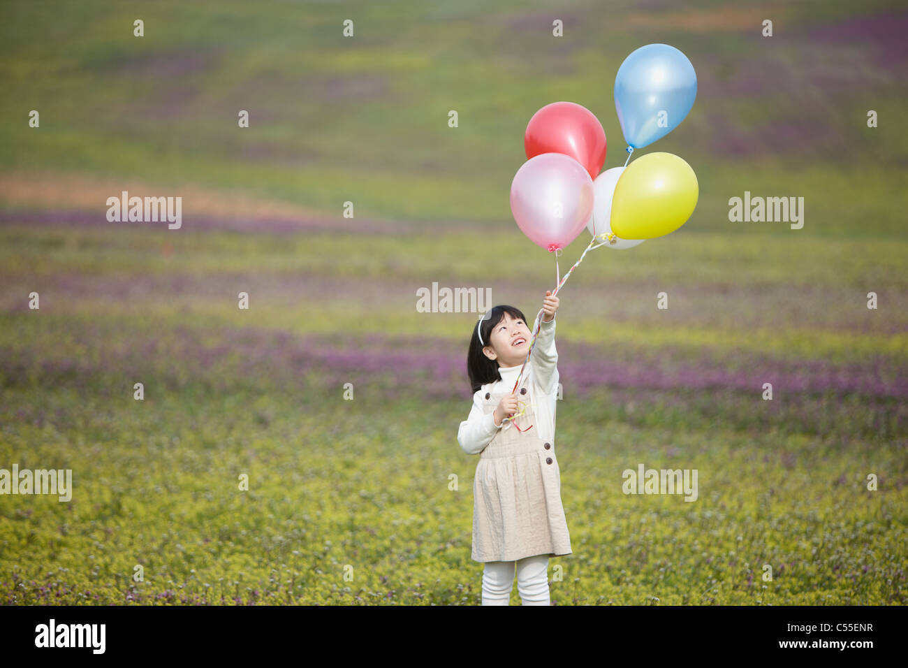 Girl holding flower balloon hi-res stock photography and images - Alamy