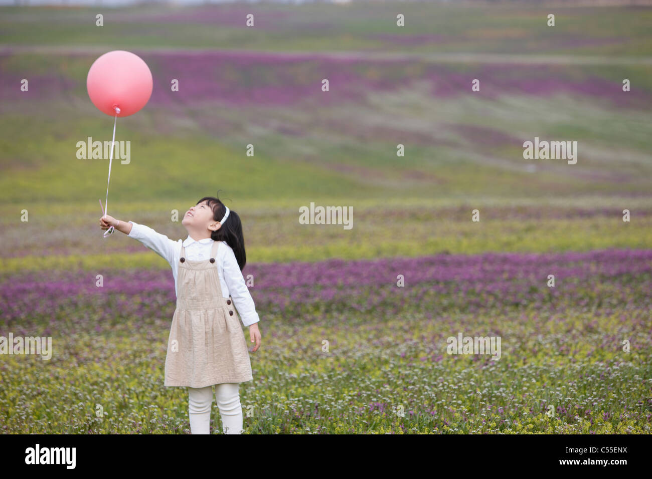 Girl holding flower balloon hi-res stock photography and images - Alamy