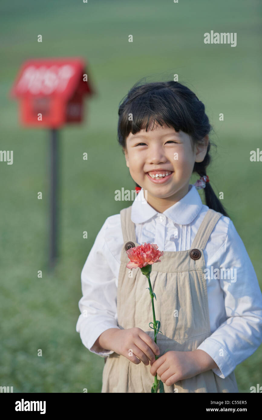 A girl holding a flower Stock Photo - Alamy