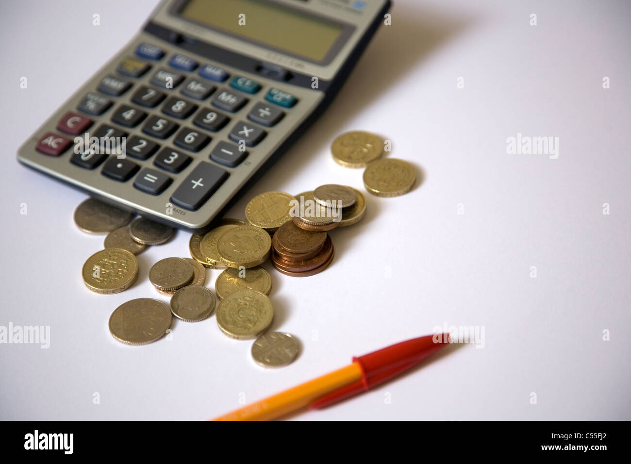 Calculator, pen and change Stock Photo Alamy