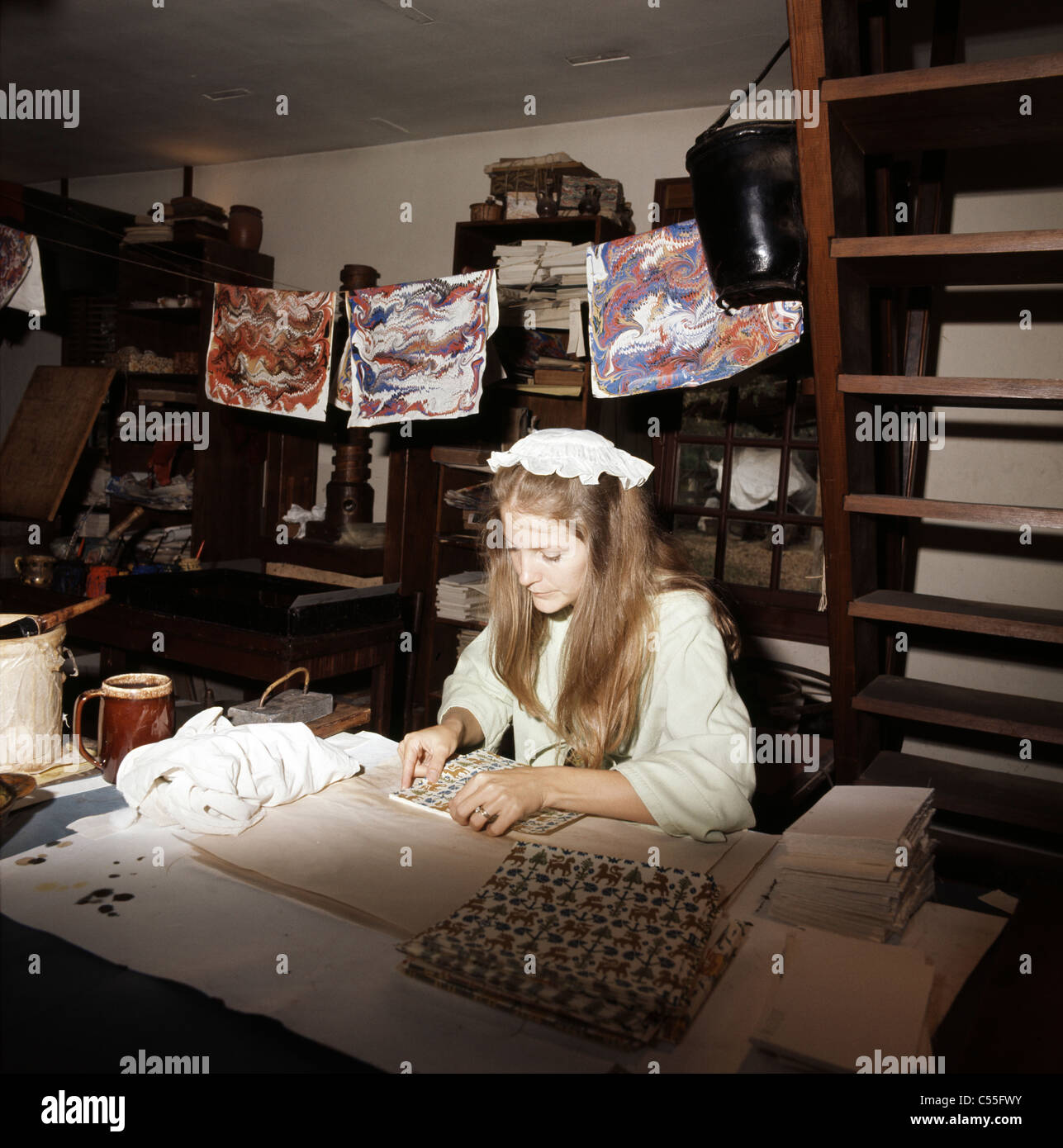 USA, Virginia, Williamsburg, Colonial Williamsburg, Woman binding books in workshop Stock Photo