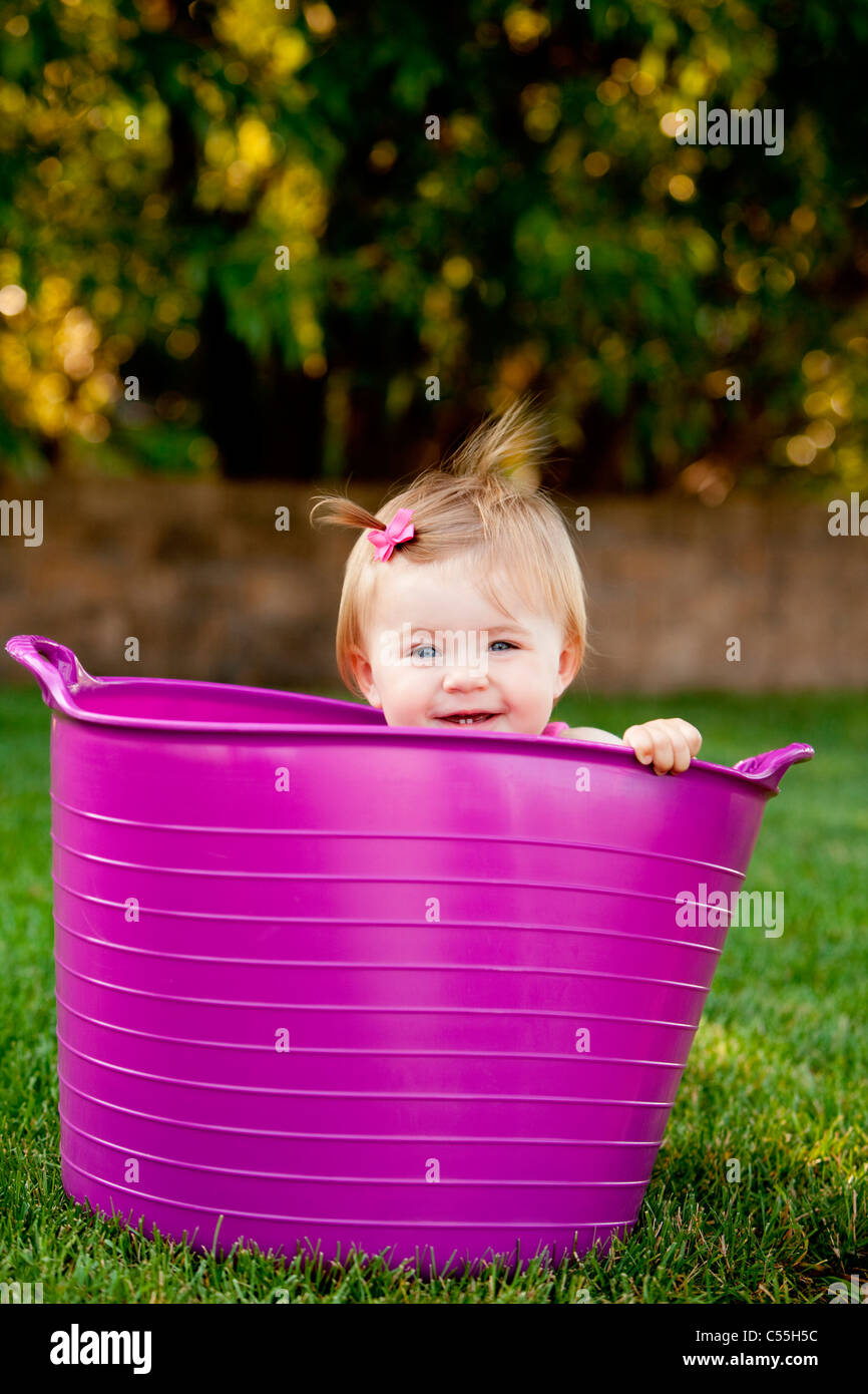 Baby girl peeking from a bathtub, Traverse City, Grand Traverse County