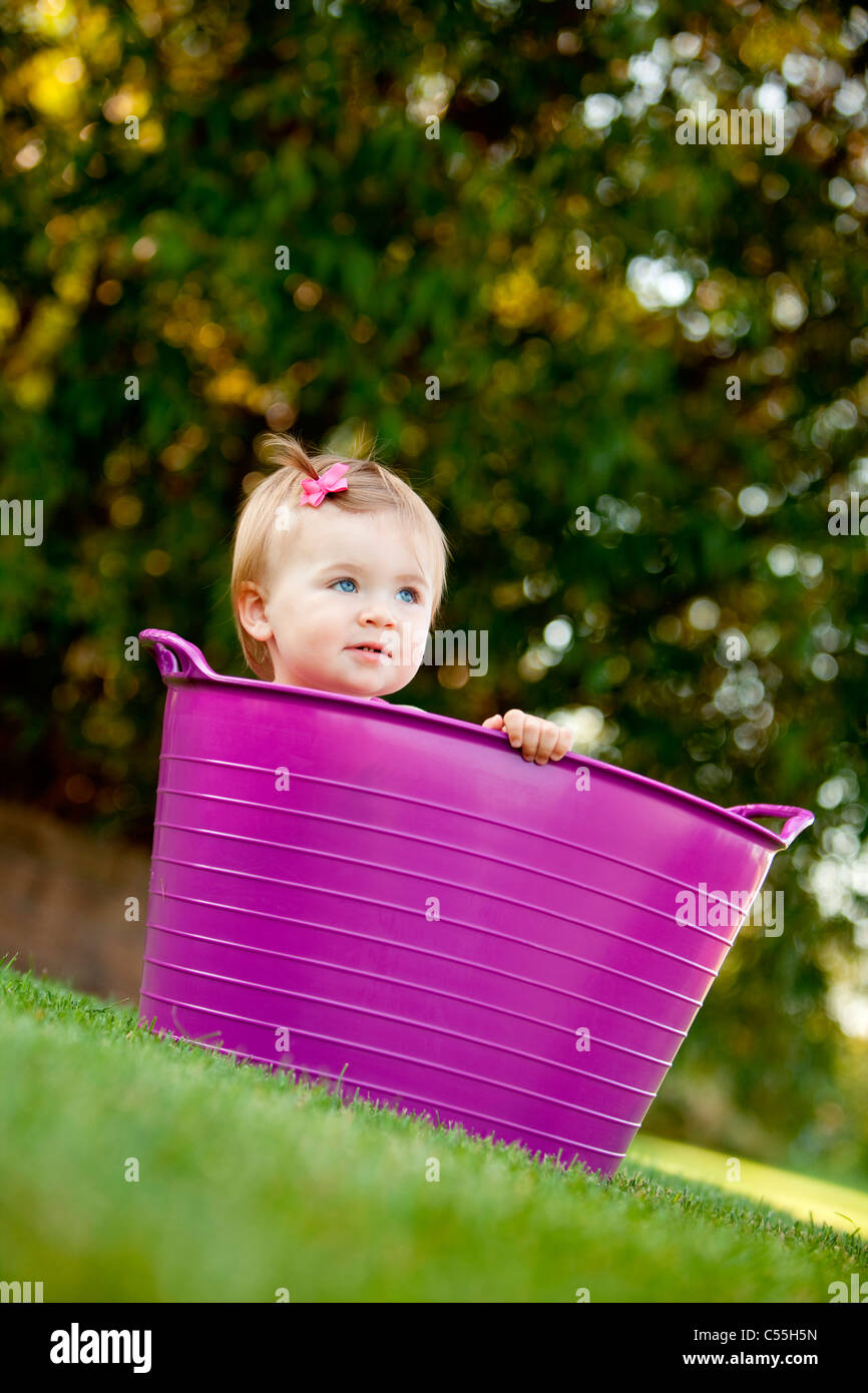 Baby girl peeking from a bathtub, Traverse City, Grand Traverse County