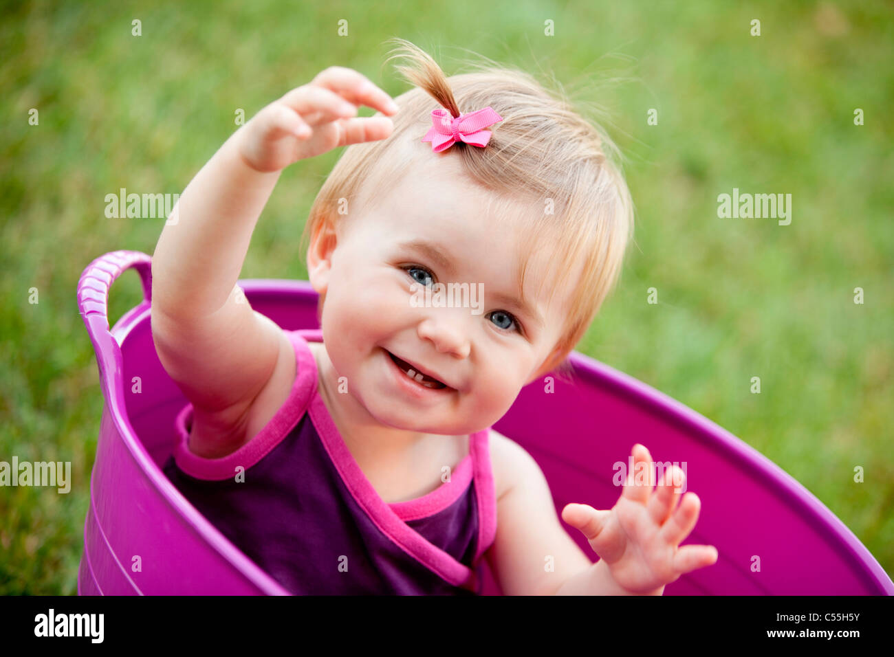 Portrait of a baby girl smiling in a bathtub, Traverse City, Grand