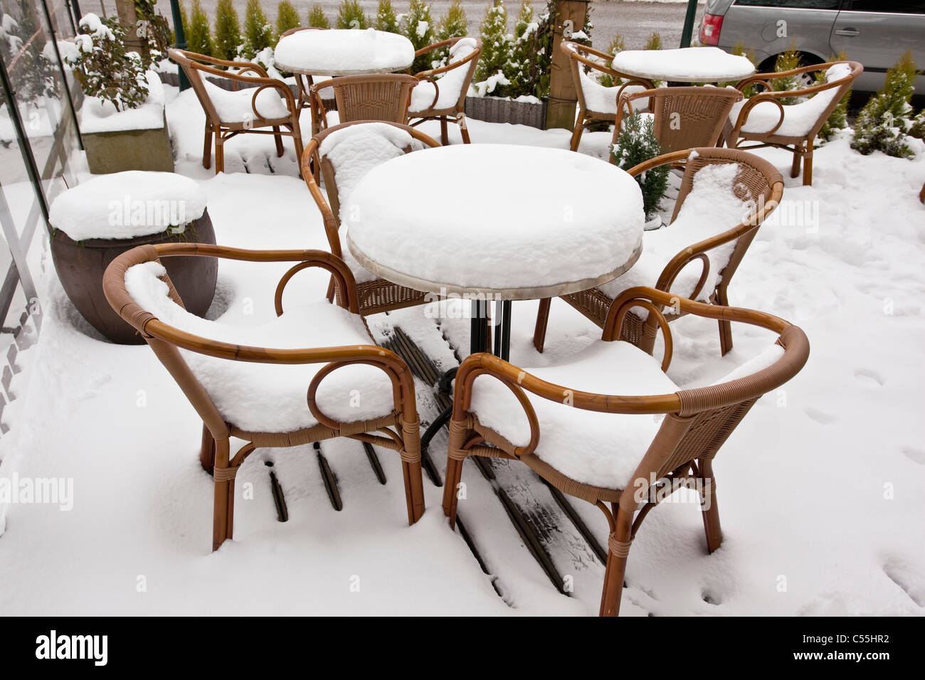 The Netherlands, Slenaken, Chairs of outdoor cafe, covered with snow. Stock Photo