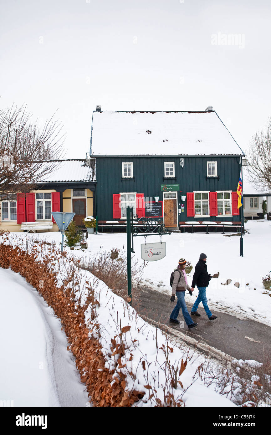 The Netherlands, Epen, Frame houses. Winter, snow. Hikers. Stock Photo