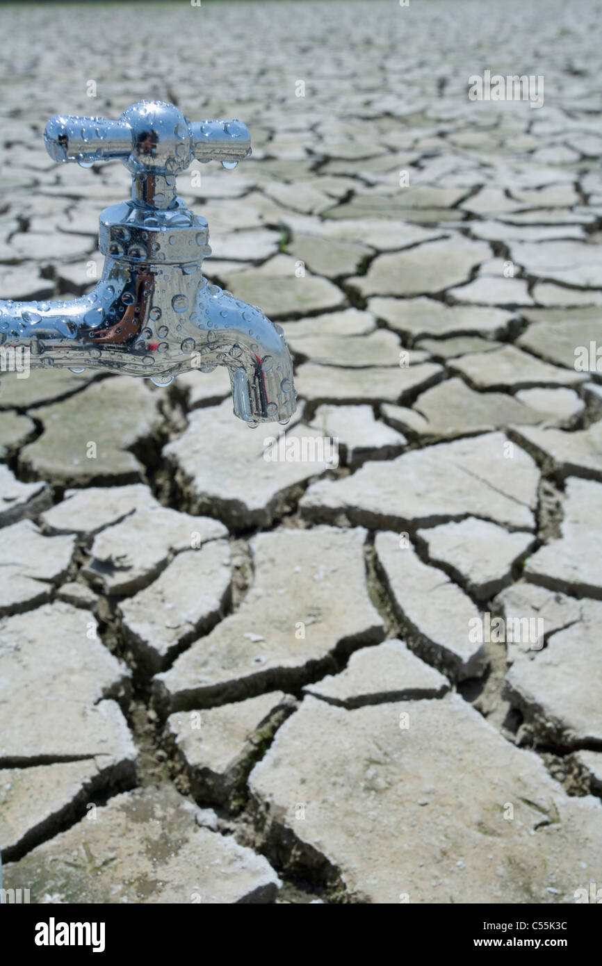 close up tap in cracked field Stock Photo