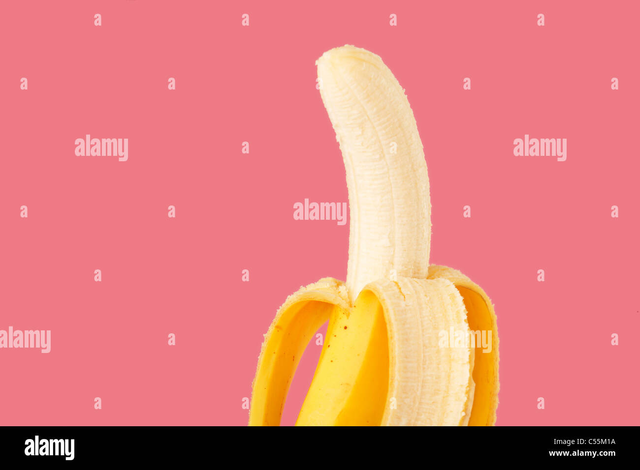A banana ready for eating on pink background Stock Photo Alamy