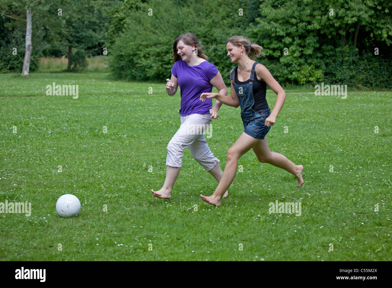 two young girls playing football Stock Photo Alamy