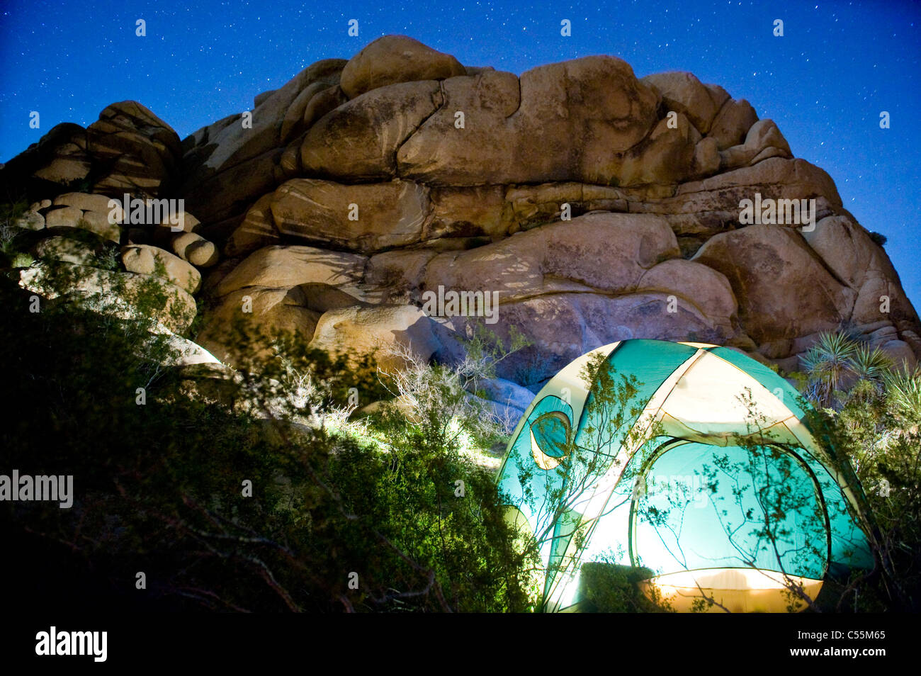 Dome tent lit up at night, Joshua Tree National Monument, California