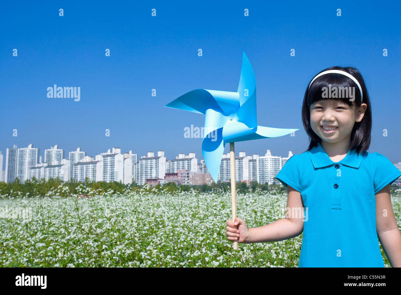 girl holding big pinwheel in buchwheat flower field Stock Photo - Alamy
