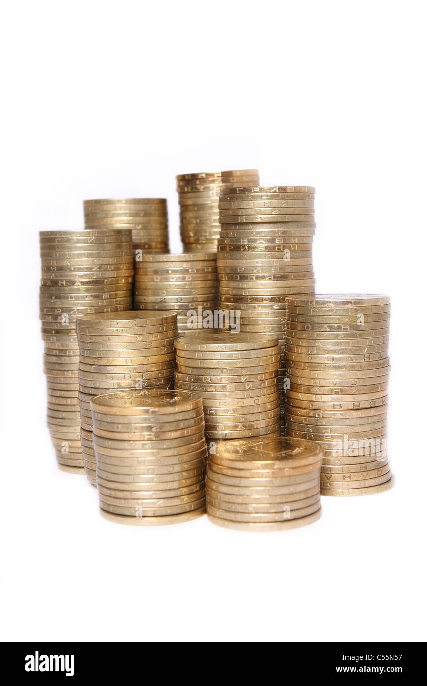 It shows the piles of coins on white background Stock Photo - Alamy