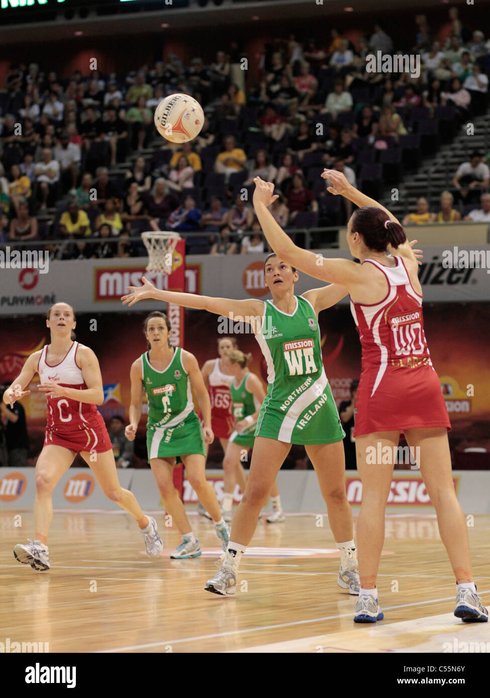 08.07.2011 Jade Clarke of England(right) lobs a pass over Hannah Irvine during the Quarter-finals between England and Northern Ireland, Mission Foods World Netball Championships 2011 from the Singapore Indoor Stadium in Singapore. Stock Photo
