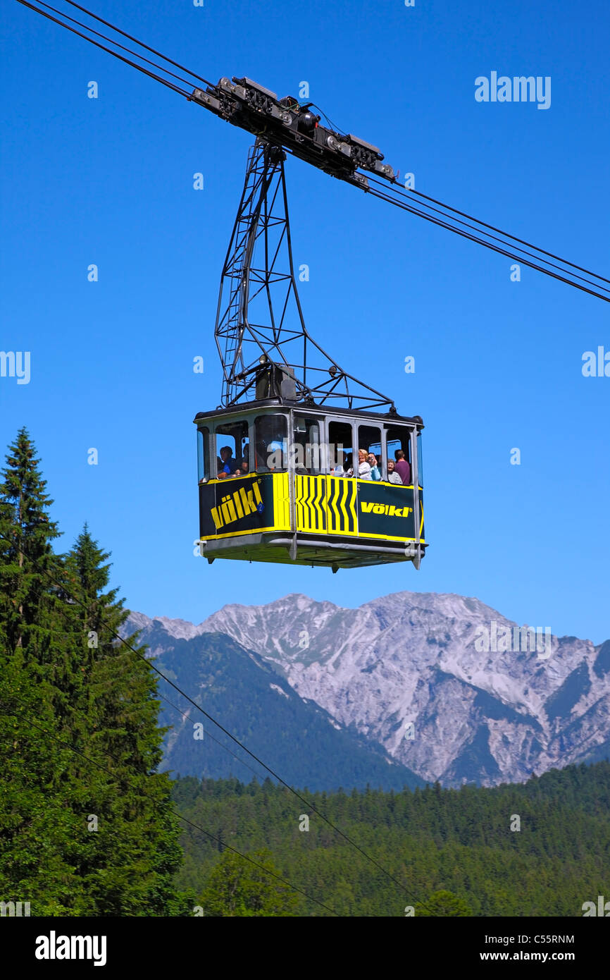 A mountain gondola / cable car on its way from the cable car station in Eibsee to the summit of Zugspitze, Bavaria, Germany Stock Photo