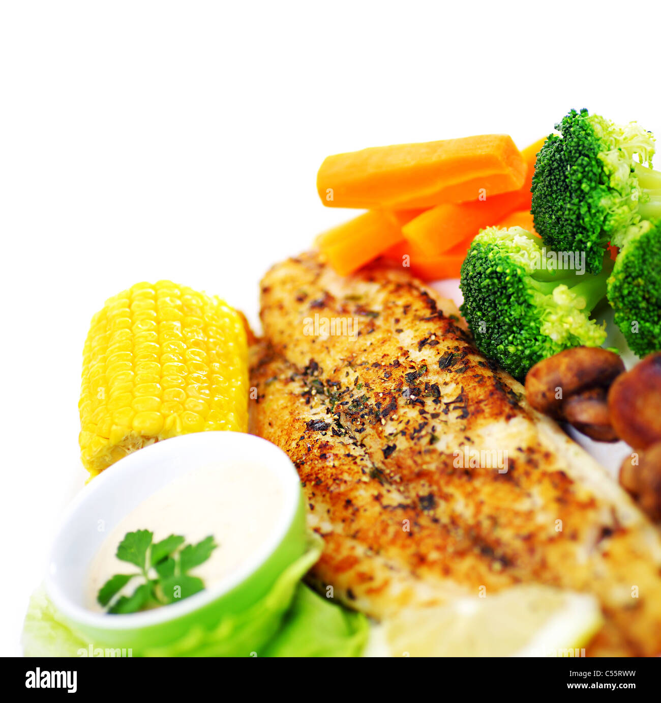 Tasty healthy fish fillet with steamed vegetables, isolated on white