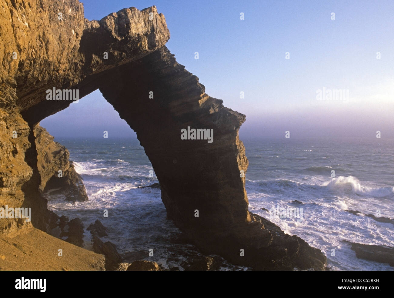 The Bogenfels a 200 foot rock arch south of Pomona on Namibia's Diamond coast Stock Photo