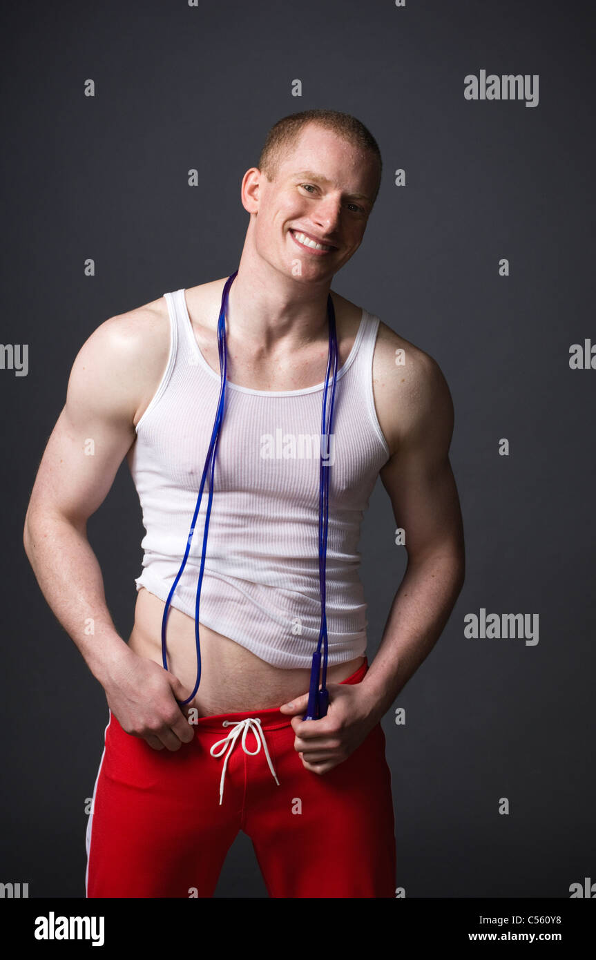 Male athlete smiling with a jump rope Stock Photo - Alamy