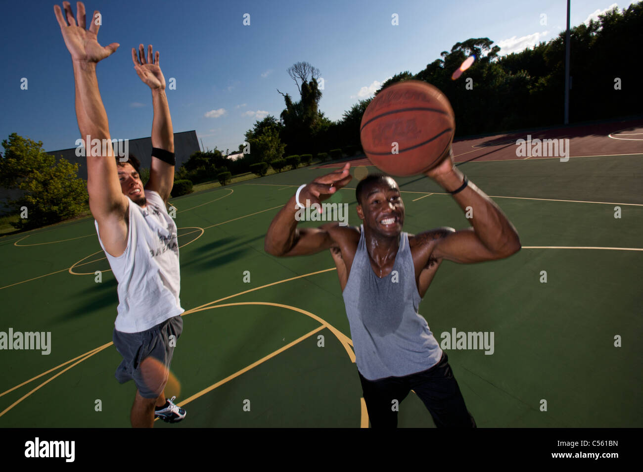 males playing outdoor basketball game Stock Photo Alamy