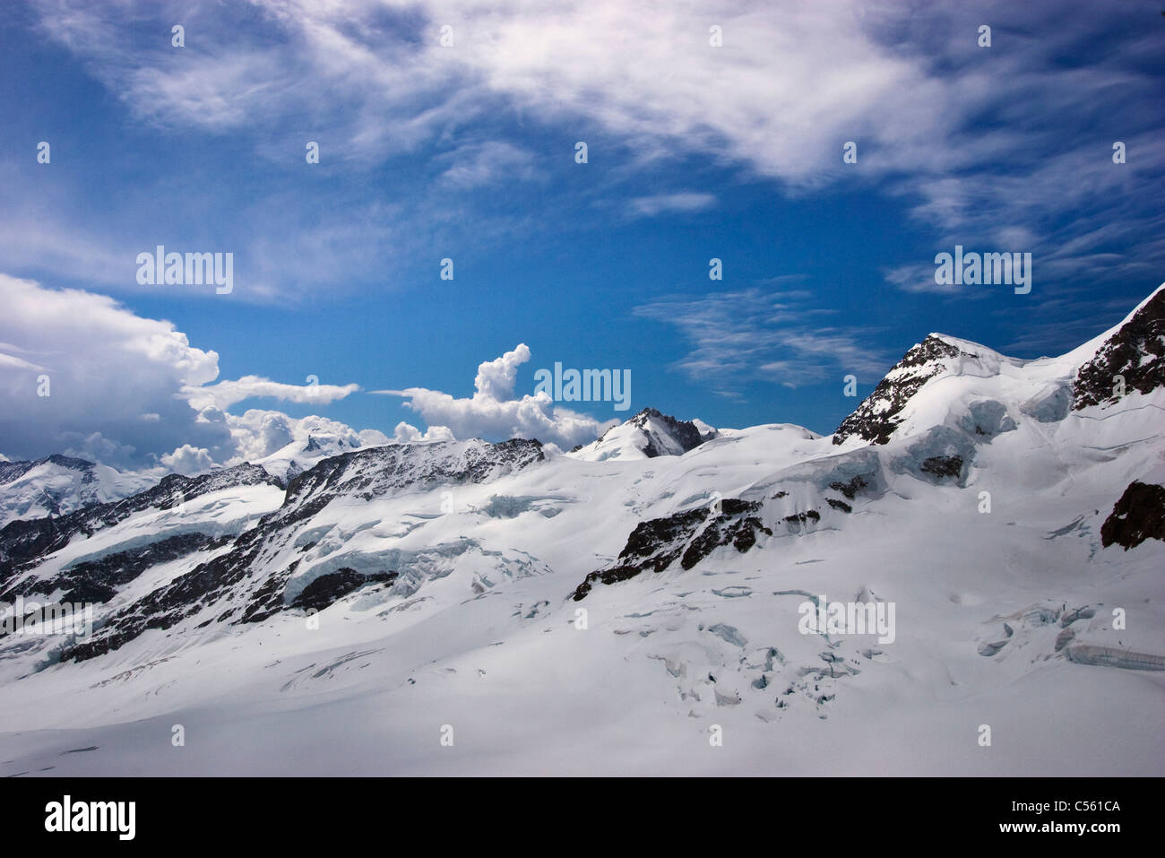 Clouds over snowcapped mountain range, Jungfraujoch, Bernese Oberland, Berne Canton, Switzerland Stock Photo