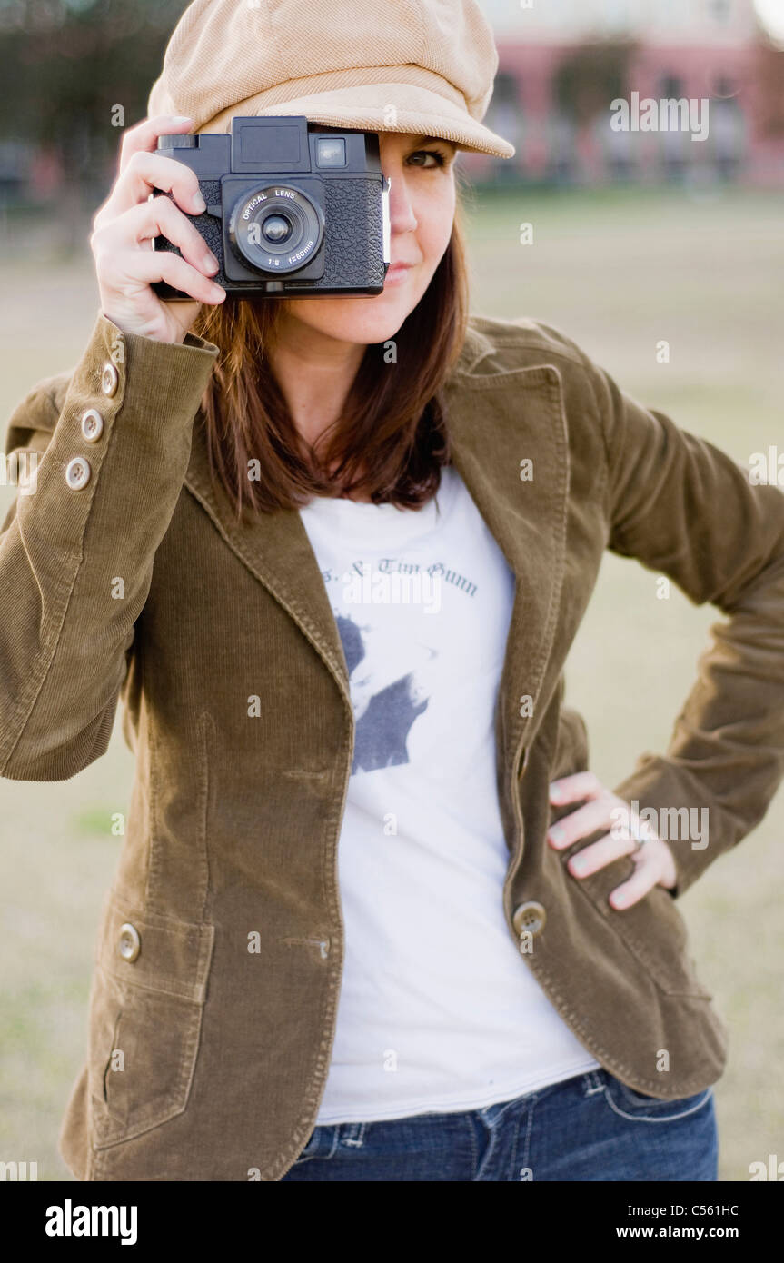 Close-up of a young woman holding a camera Stock Photo - Alamy
