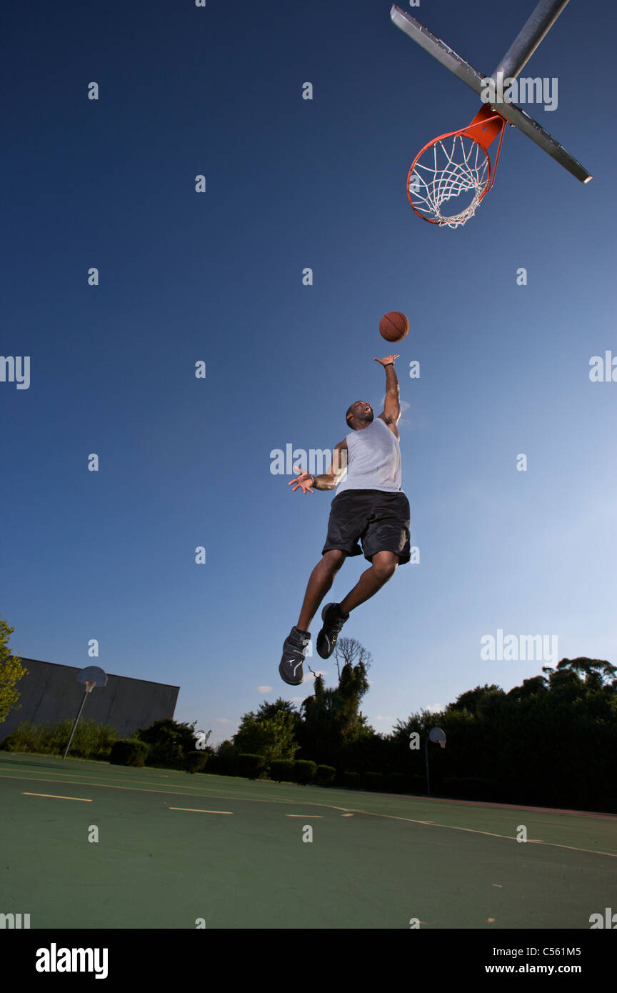 male scoring layup on outdoor basketball goal Stock Photo Alamy