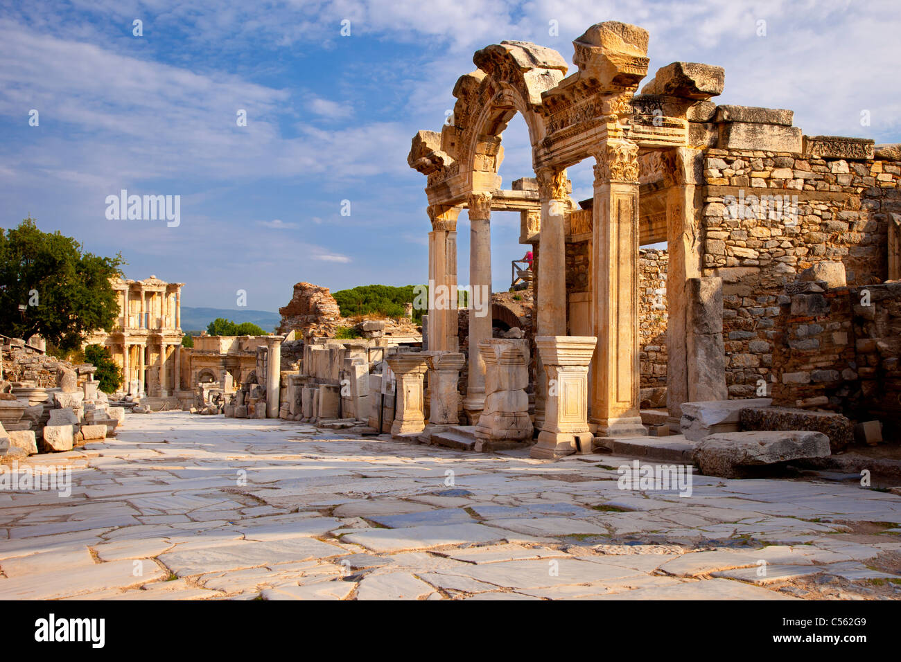 Temple of Hadrian with Library of Celsus beyond along paved Street of Curetes in ancient Ephesus, near Selcuk Turkey Stock Photo