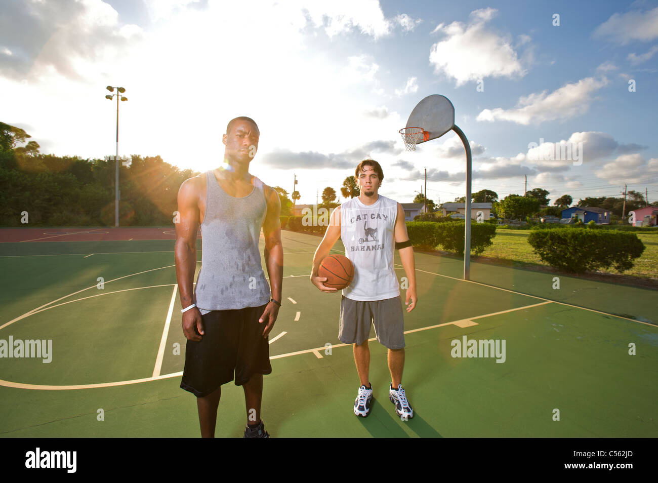 males after after playing basketball on outdoor court, dramatic sky Stock Photo