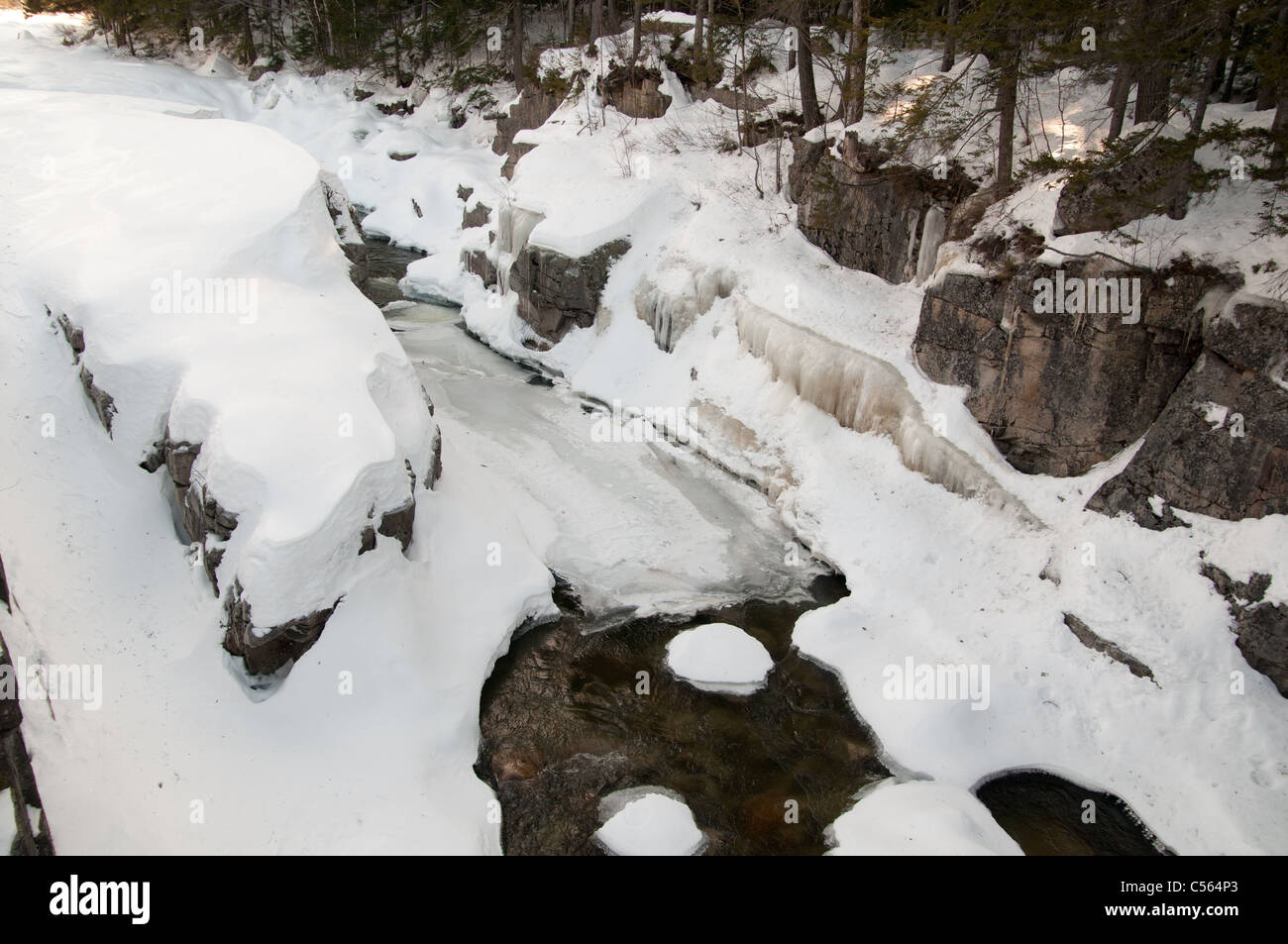 Ice and snow blanket the Swift River in the White Mountain National Forest Stock Photo