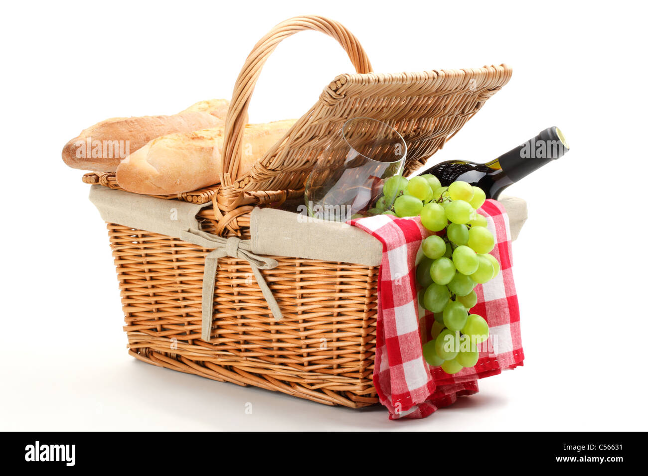 Picnic basket filled with fruit,bread and red wine. Stock Photo