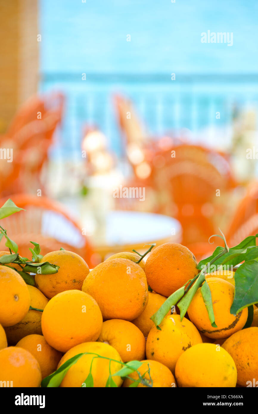 fresh mediterranean oranges in-front of a seaside restaurant Stock Photo
