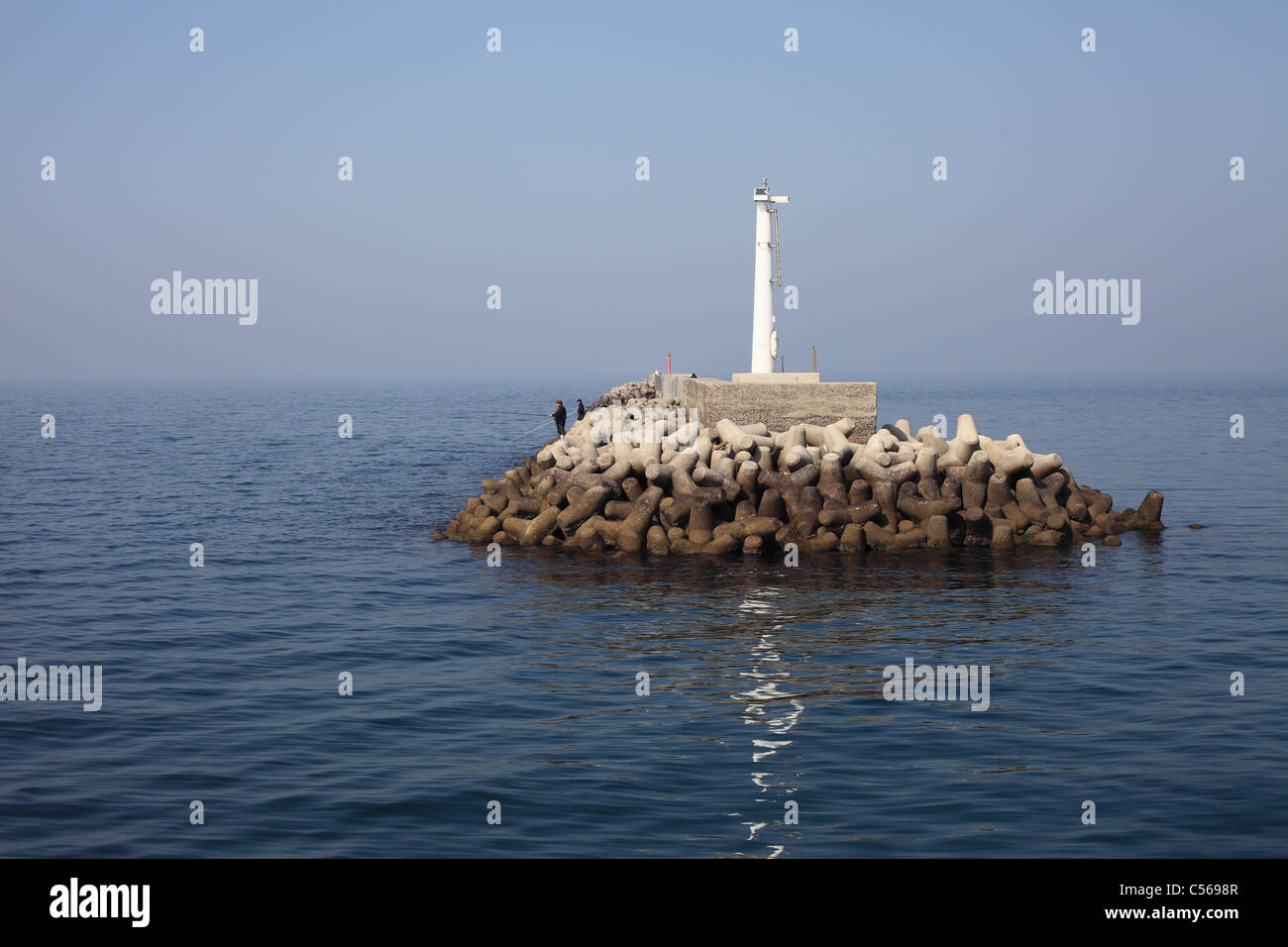 Lighthouse in the sea Stock Photo