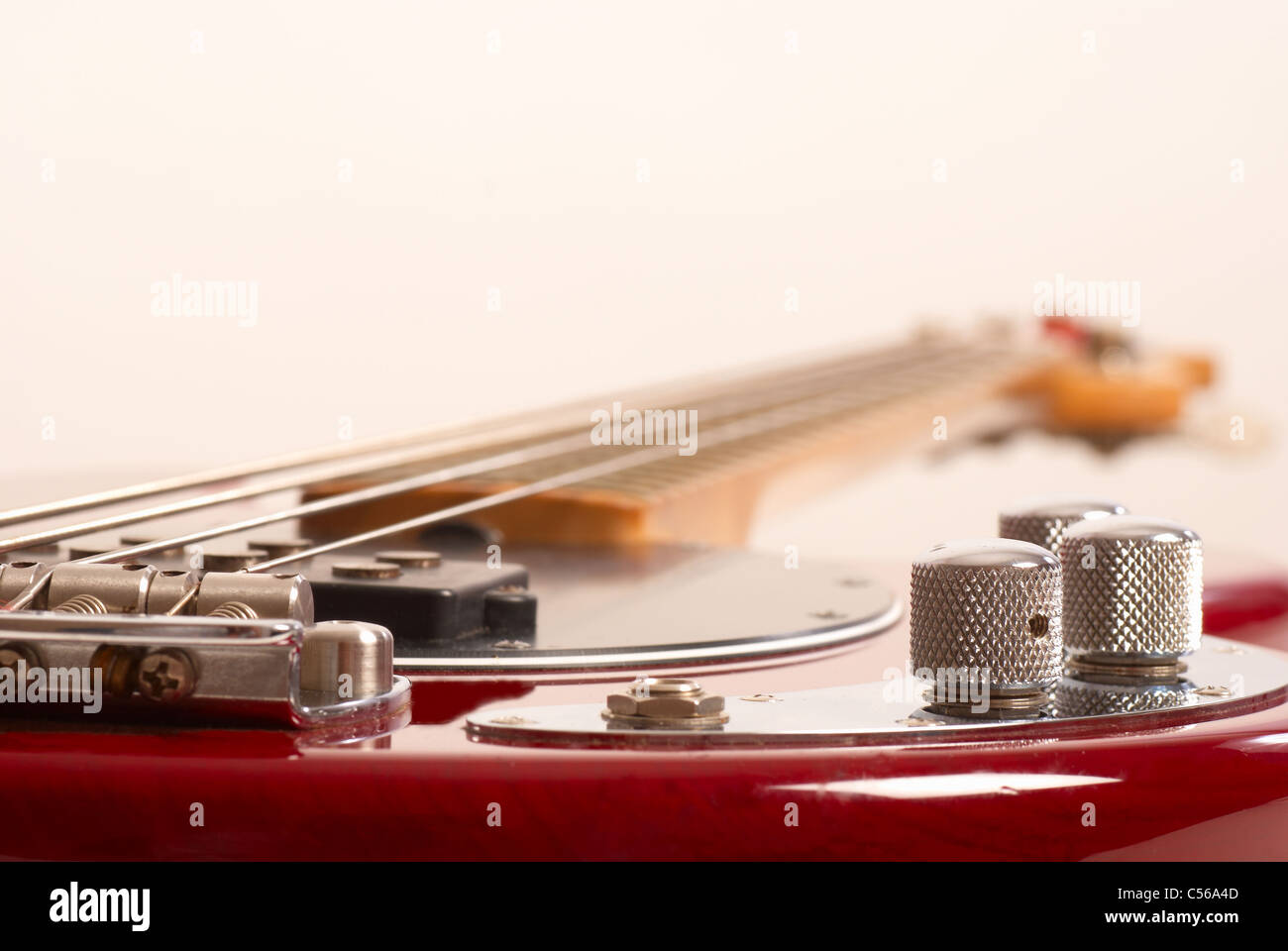 Electrical 4 String Instrument Wooden four string fretted electric bass instrument Stock Photo - Alamy