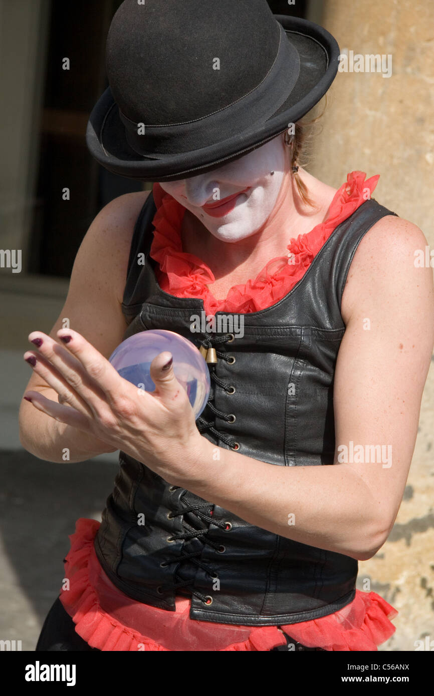 A woman juggler performing on the street: Bath, Somerset, UK Stock Photo