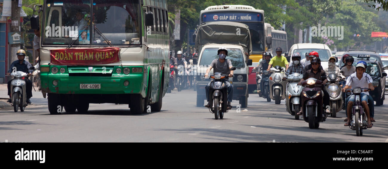 Hanoi, Vietnam, busy traffic road scene with smoky exhausts, cars, motorcycles, bus Stock Photo