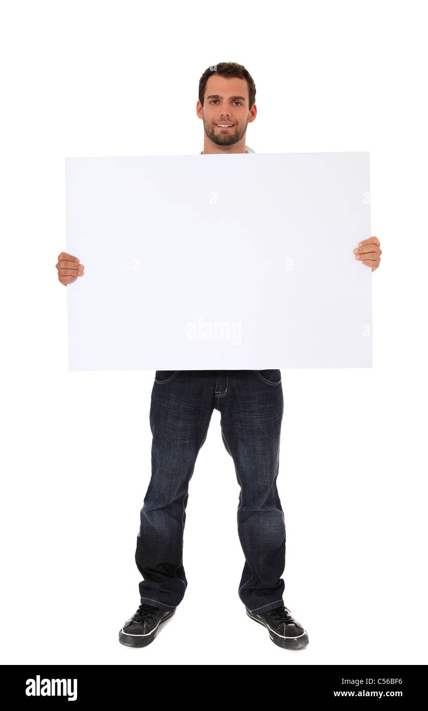 Attractive young man holding blank white sign. All on white background