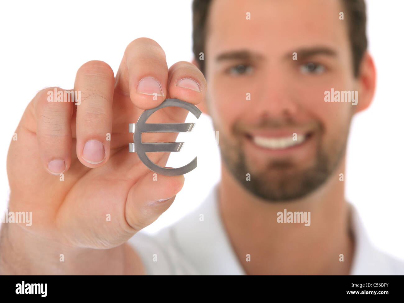 Portrait of a young man holding a Euro symbol. Selective focus on Euro symbol in foreground. All on white background. Stock Photo