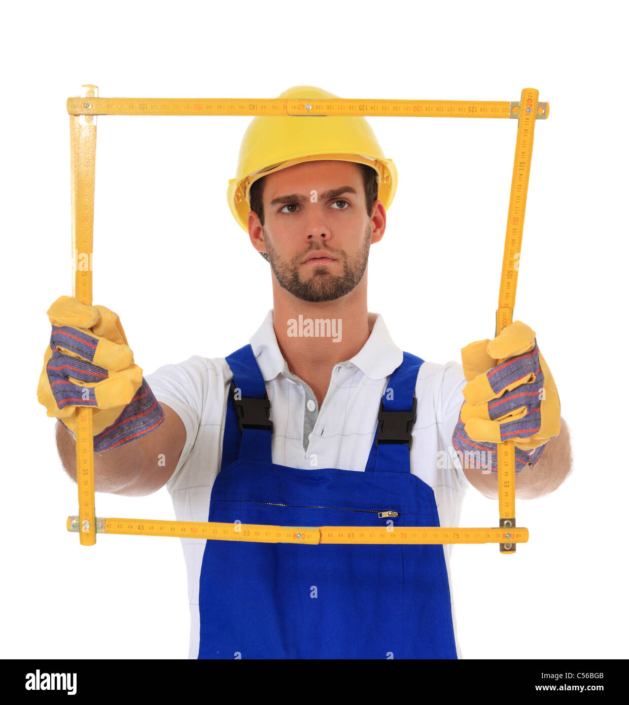 Manual worker holding yardstick. All on white background. Stock Photo