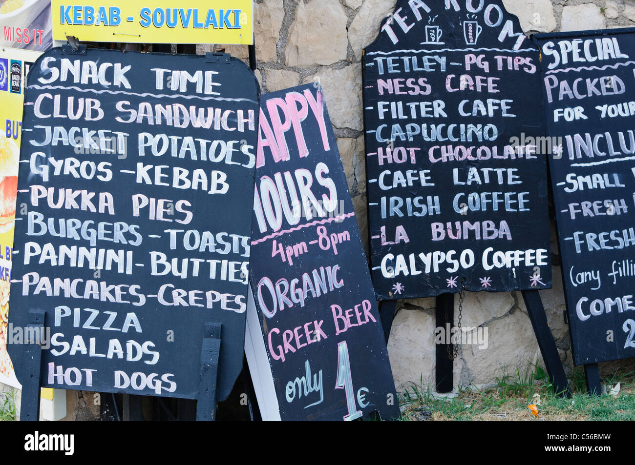 Signs outside Greek snack bars and pubs Stock Photo