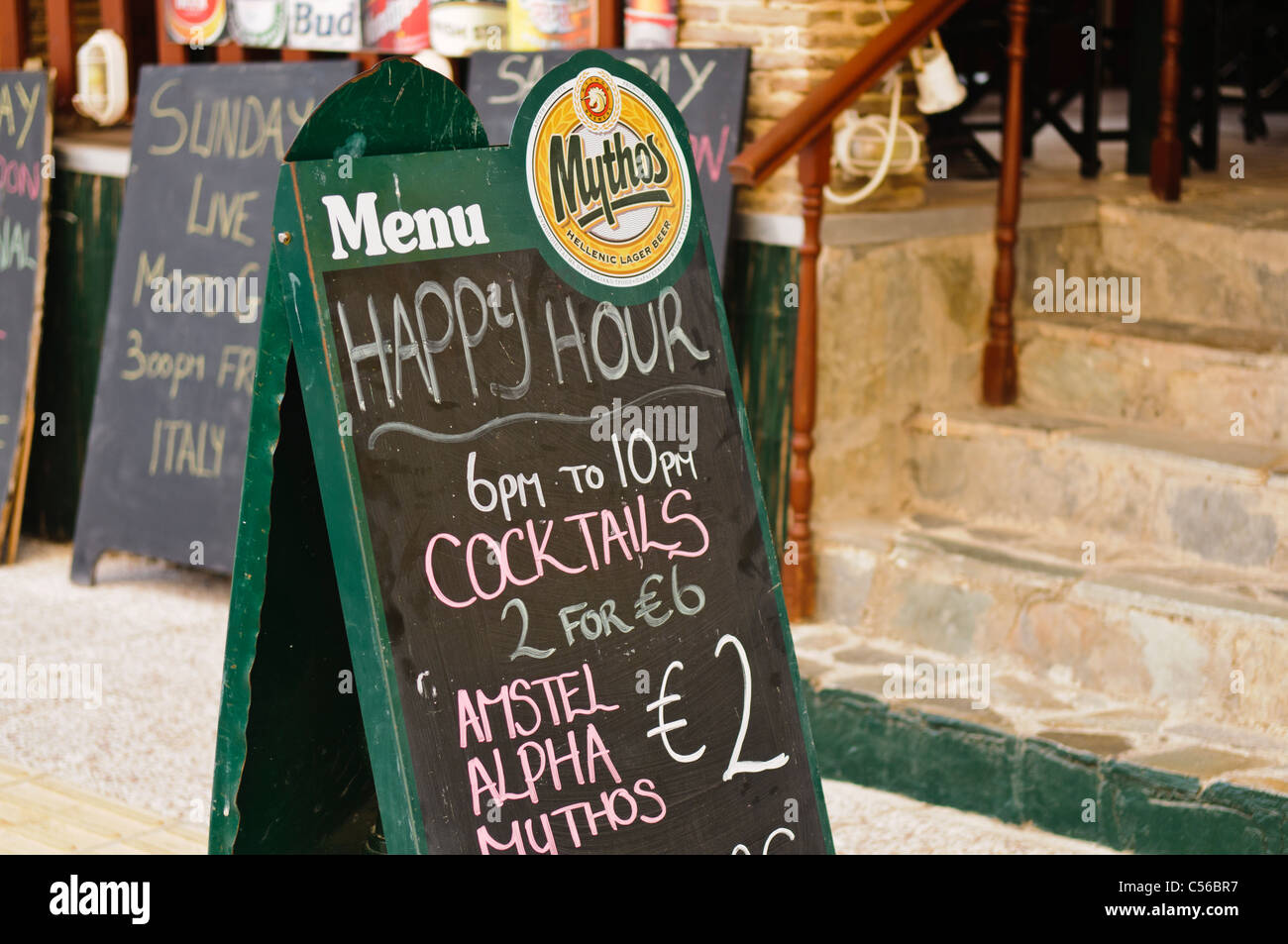 Sign outside a Greek bar advertising Happy Hour from 6pm to 10pm with
