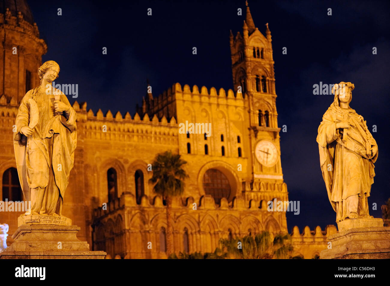 St Agata and St Rosalia before Palermo's Cathedral floodlit at night. Stock Photo
