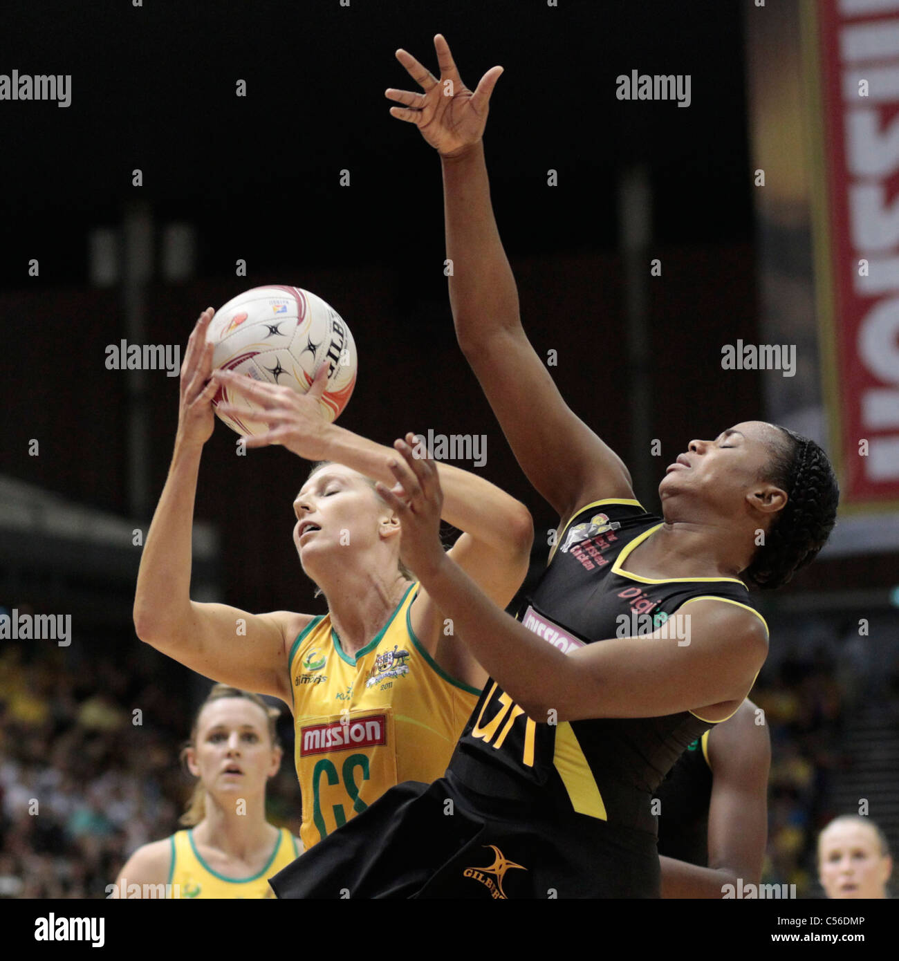 09.07.2011 Catherine Cox of Australia(left) battles with Althea Byfield for the ball during the Semi-finals between Australia and Jamaica, Mission Foods World Netball Championships 2011 from the Singapore Indoor Stadium in Singapore. Stock Photo