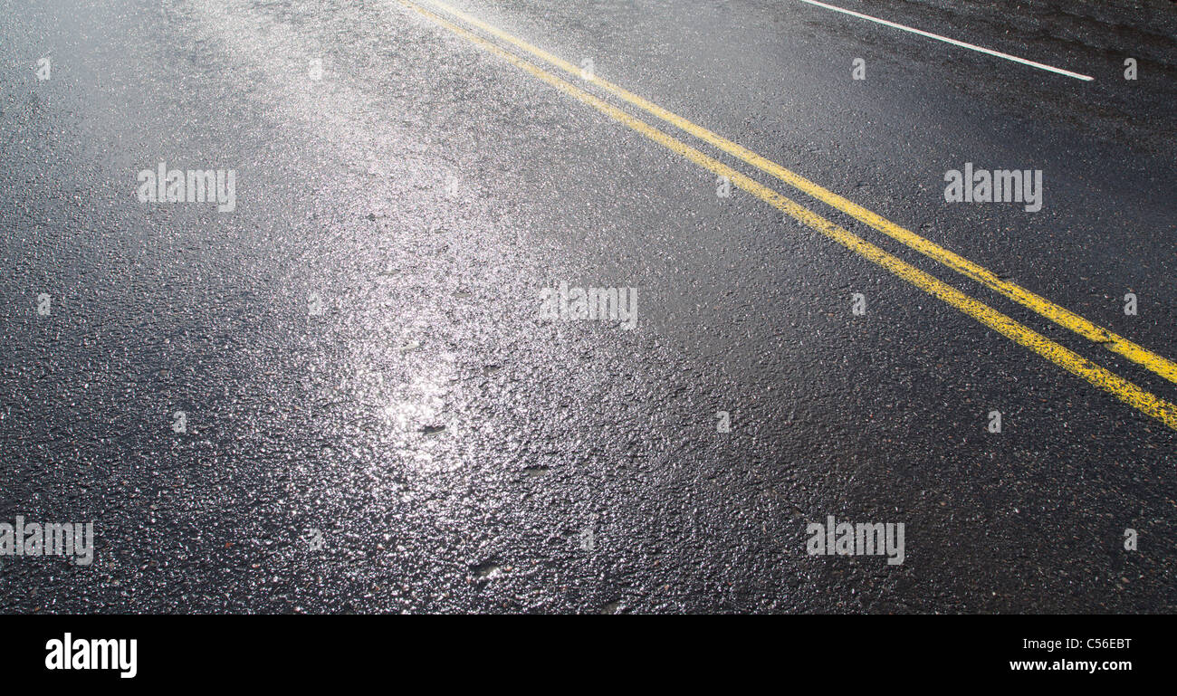 Wet tarmac surface after rain Stock Photo