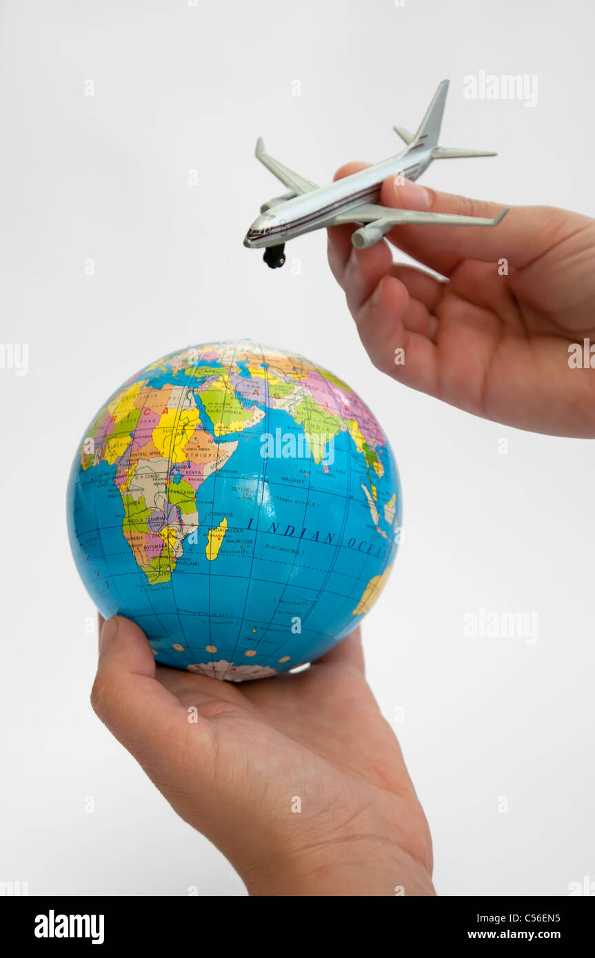 Globe and plane with two hands Stock Photo