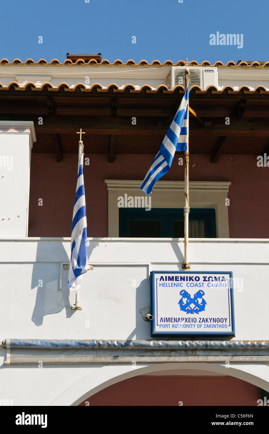 Greek coast guard building with flags Stock Photo